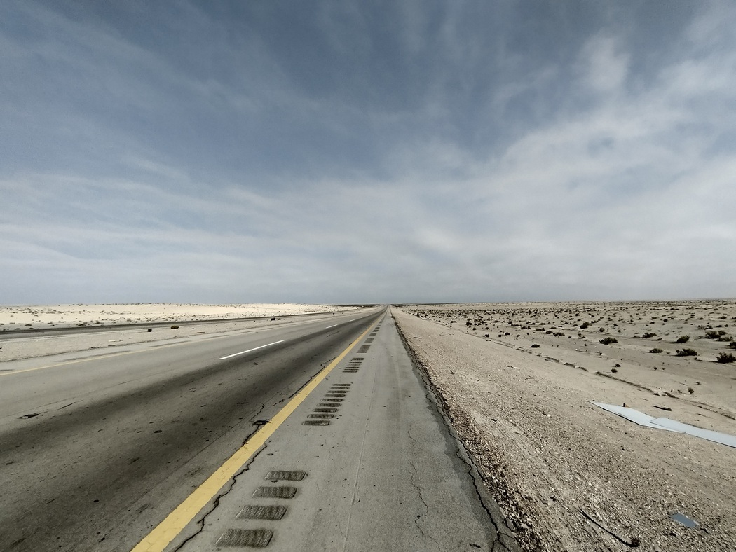 Endlose gerade Straße in der Wüste